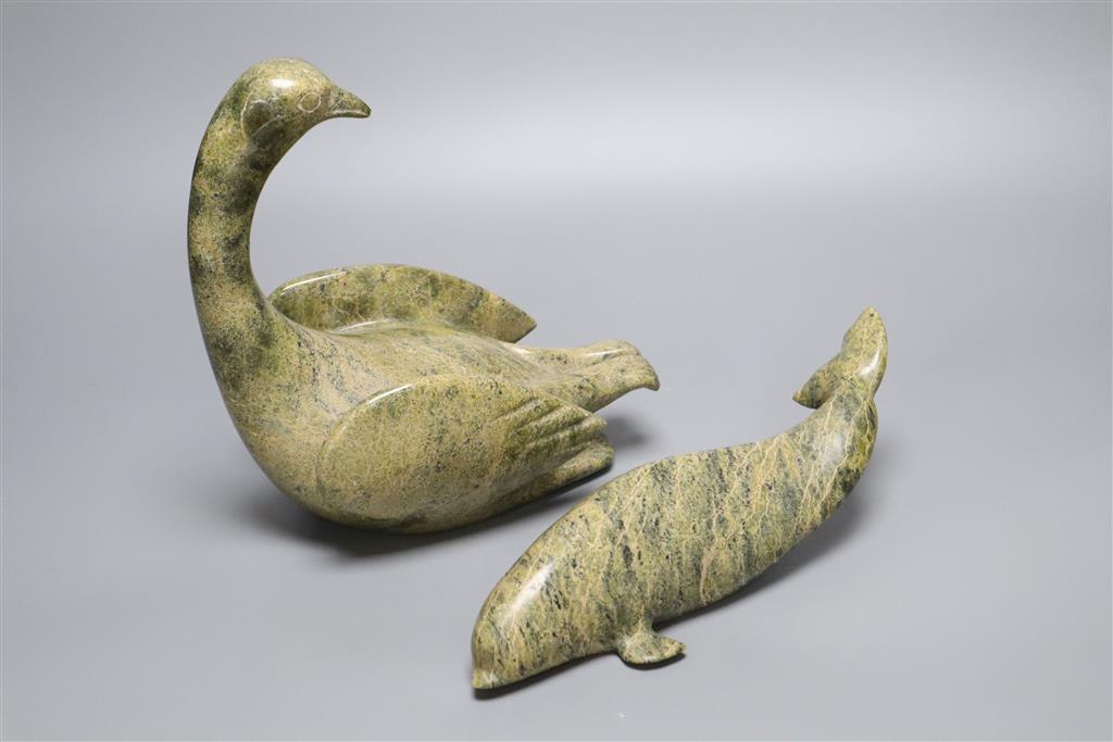 A carved Inuit whale and a similar carved swan